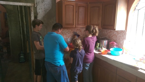 Douglas teaching the kids to fry green bananas
